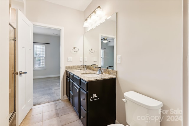 bathroom featuring tile patterned floors, vanity, an enclosed shower, toilet, and ceiling fan