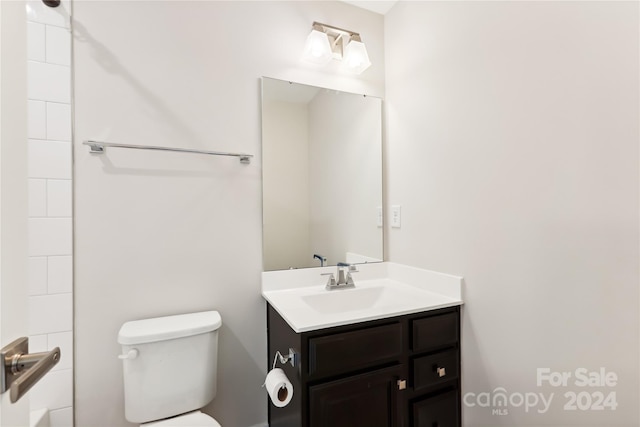 bathroom featuring toilet and vanity