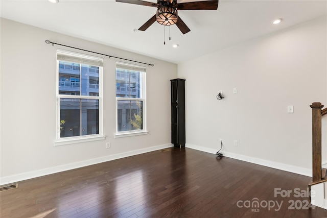 empty room featuring dark hardwood / wood-style floors and ceiling fan