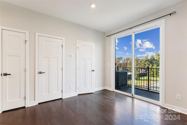 unfurnished bedroom with dark hardwood / wood-style floors and access to exterior