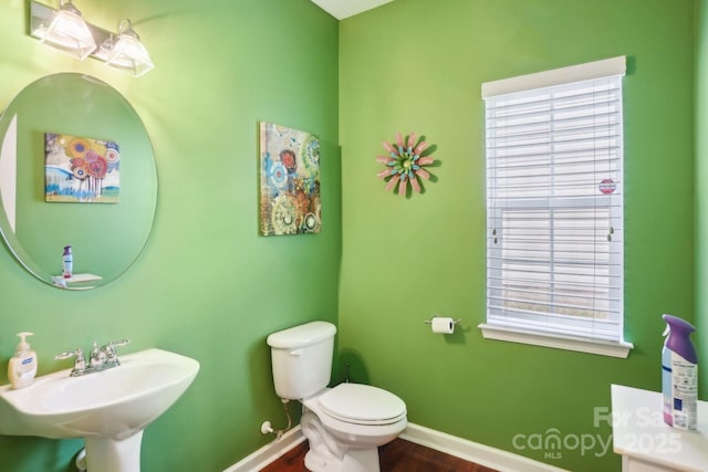 bathroom featuring sink, toilet, and hardwood / wood-style floors