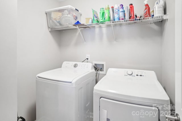 laundry room featuring washing machine and clothes dryer