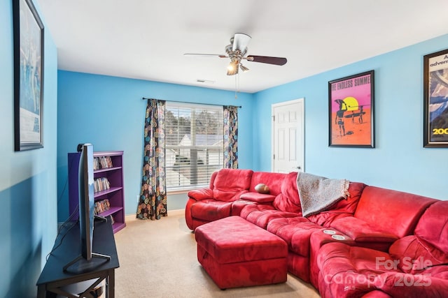 carpeted living room with ceiling fan