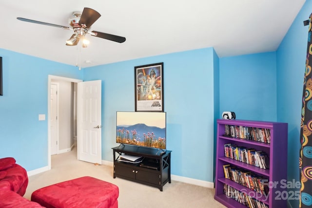 living area with carpet flooring and ceiling fan