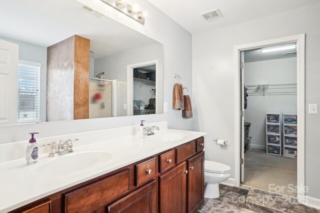 bathroom with vanity, toilet, and an enclosed shower