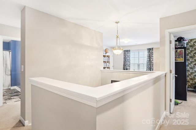 hallway with light colored carpet