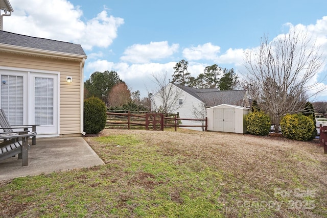 view of yard featuring a patio and a shed