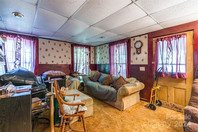 living room featuring a paneled ceiling, plenty of natural light, and carpet floors