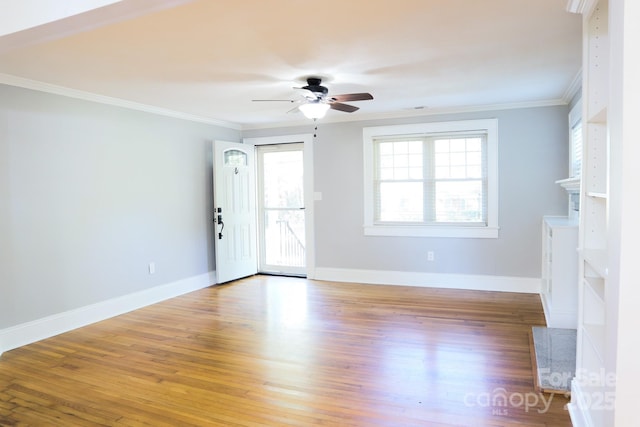 unfurnished living room featuring hardwood / wood-style floors, ornamental molding, and ceiling fan