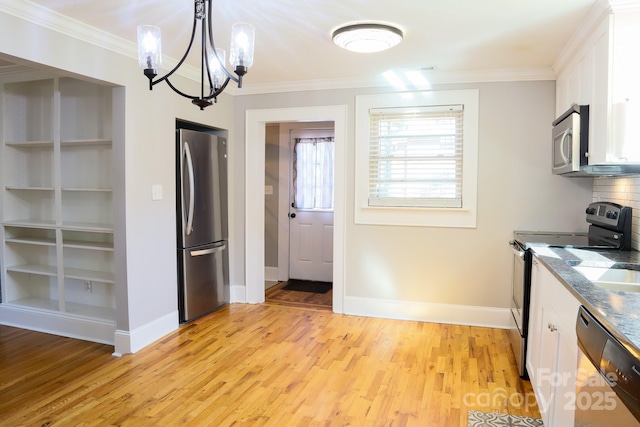 kitchen featuring light hardwood / wood-style flooring, a chandelier, pendant lighting, stainless steel appliances, and white cabinets