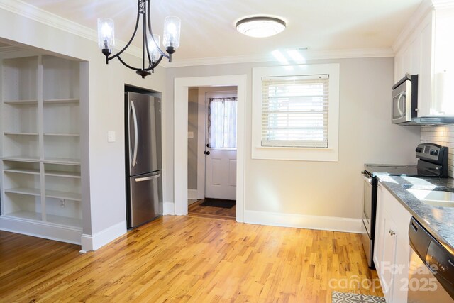 kitchen featuring light hardwood / wood-style flooring, a chandelier, pendant lighting, white cabinetry, and appliances with stainless steel finishes