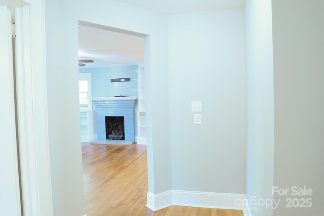 hallway with light hardwood / wood-style flooring