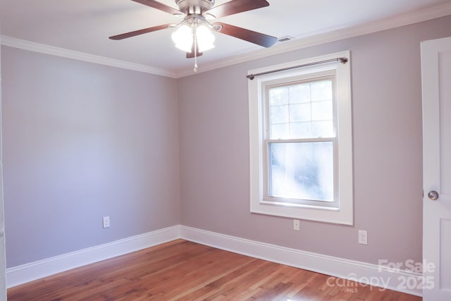 spare room with ornamental molding, ceiling fan, and light hardwood / wood-style flooring