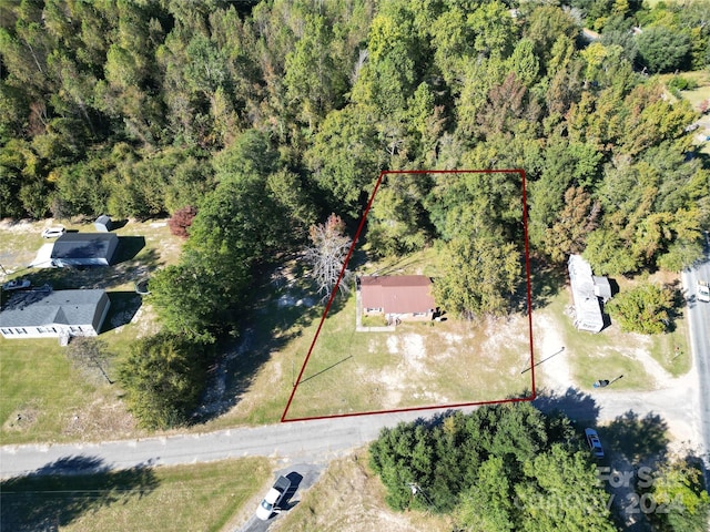 aerial view of property's location with property boundaries highlighted and a forest