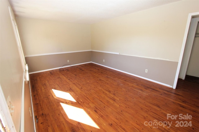 unfurnished room featuring dark hardwood / wood-style floors