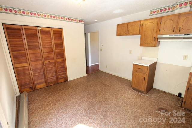 kitchen with light countertops and brown cabinetry