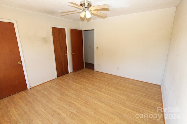 unfurnished bedroom with light hardwood / wood-style floors and ceiling fan