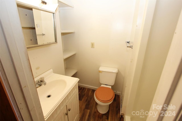 bathroom featuring vanity, toilet, and hardwood / wood-style floors