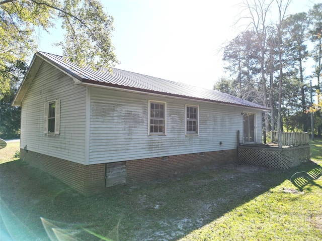 view of home's exterior featuring a yard and a wooden deck