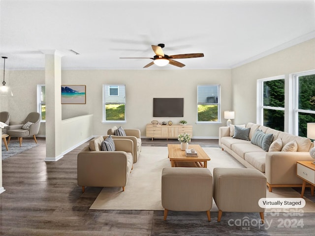 living room with ornamental molding, dark hardwood / wood-style floors, ornate columns, and ceiling fan