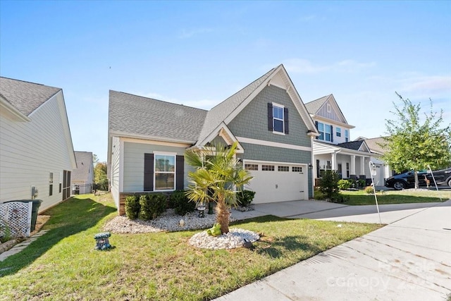 view of front of home with a front yard and a garage