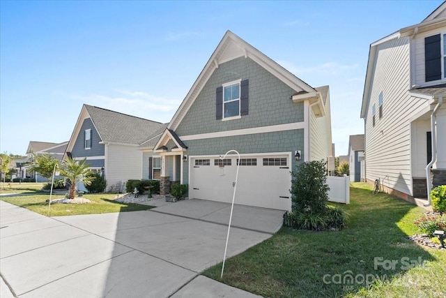 view of front of property with a garage and a front yard