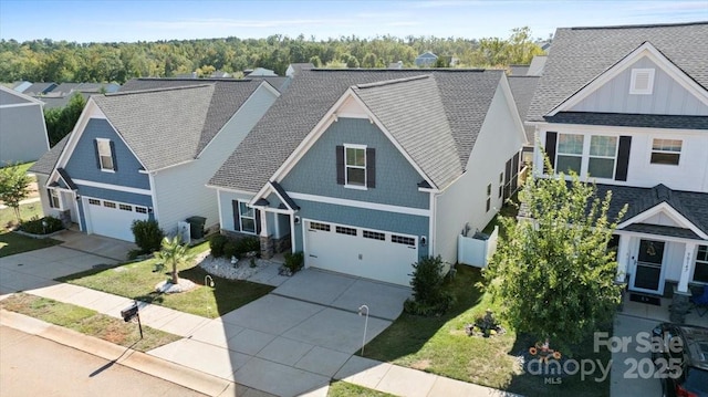 craftsman house with a front yard and a garage