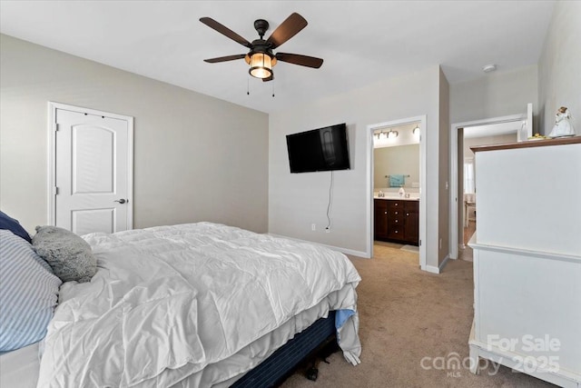 carpeted bedroom with ceiling fan and connected bathroom