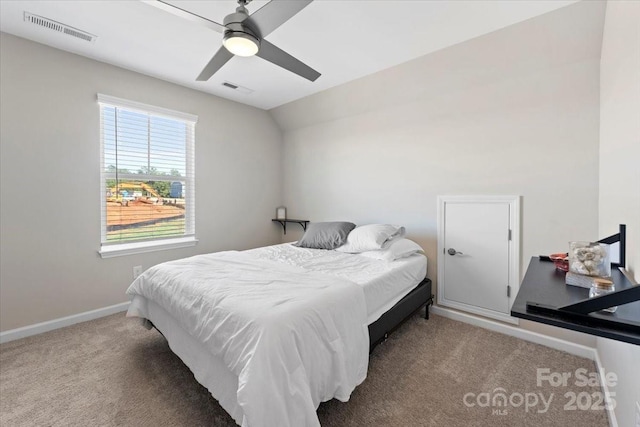 carpeted bedroom featuring ceiling fan and vaulted ceiling