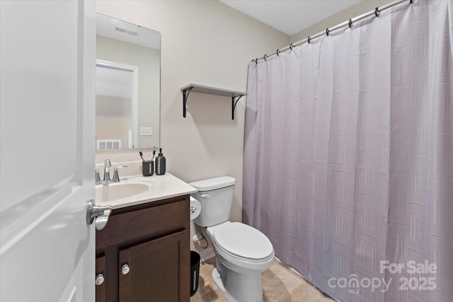 bathroom featuring toilet, tile patterned floors, and vanity