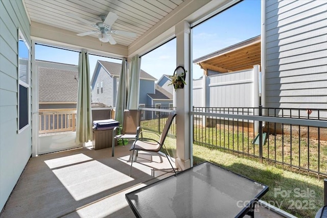 sunroom featuring ceiling fan