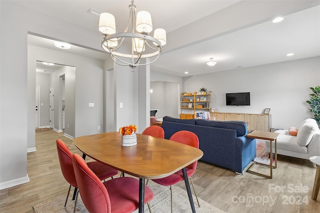 dining space featuring a notable chandelier and hardwood / wood-style flooring