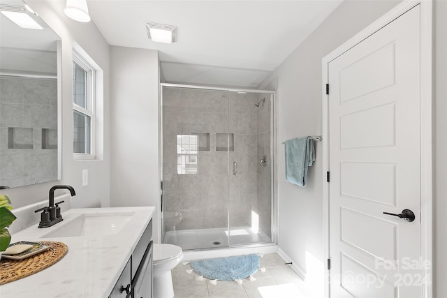 bathroom featuring vanity, tile patterned floors, toilet, and walk in shower