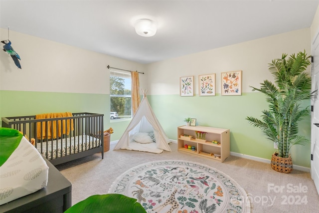 carpeted bedroom featuring a crib