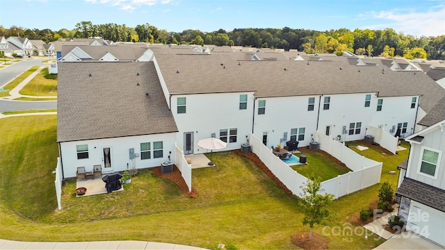 back of property featuring a patio, central AC, and a yard