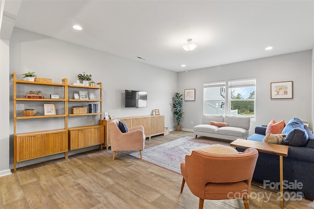 living room featuring radiator and light wood-type flooring