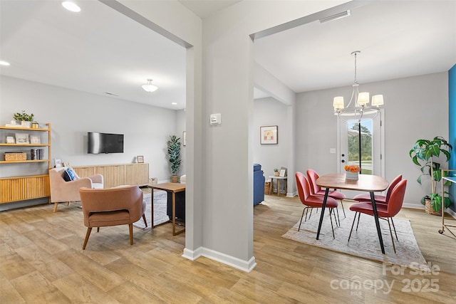 dining room featuring a chandelier and light wood-type flooring