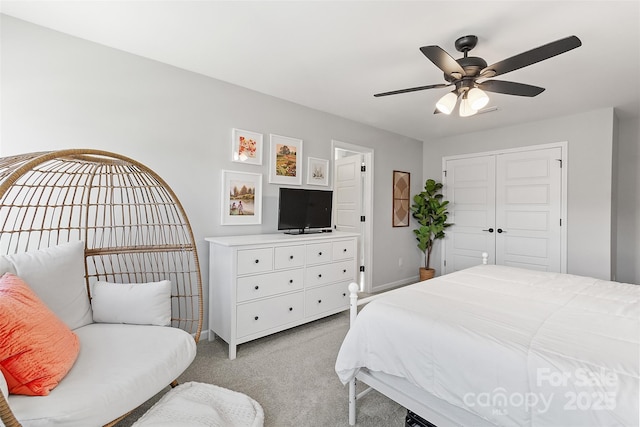 carpeted bedroom with ceiling fan and a closet