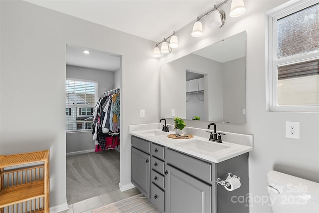 bathroom with vanity, tile patterned flooring, and toilet