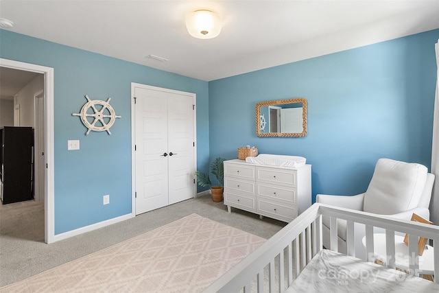 bedroom featuring light carpet and a closet