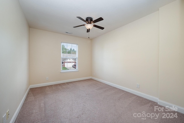 spare room with ceiling fan and carpet flooring