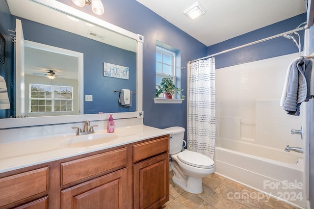 full bathroom with ceiling fan, vanity, toilet, and shower / tub combo with curtain