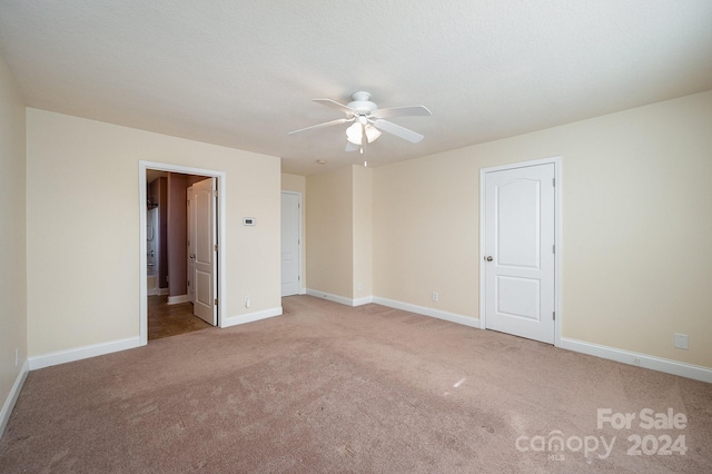 unfurnished bedroom featuring ceiling fan and light colored carpet