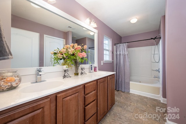 bathroom with shower / tub combo with curtain and vanity