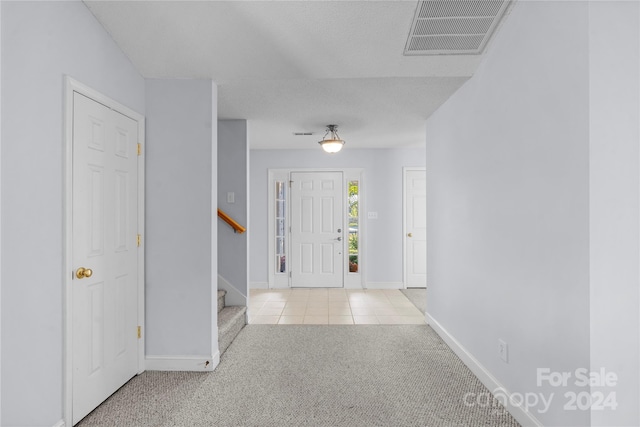 view of carpeted foyer