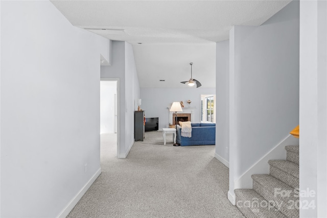 hallway with light carpet and lofted ceiling