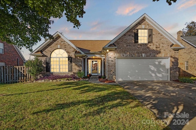 view of front of home featuring a garage and a lawn