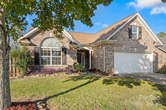 view of front of property featuring a front lawn and a garage