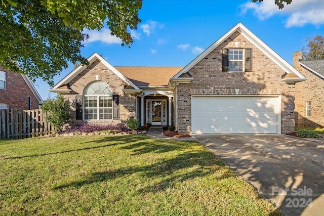 front facade featuring a front lawn and a garage