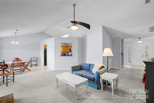 living room featuring lofted ceiling, a textured ceiling, light colored carpet, and ceiling fan with notable chandelier